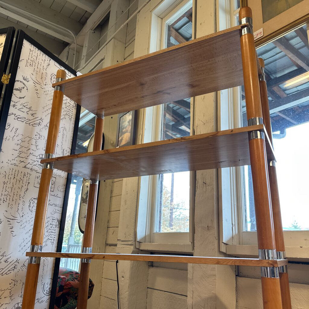 Wooden ladder shelf against a wall with decorative elements