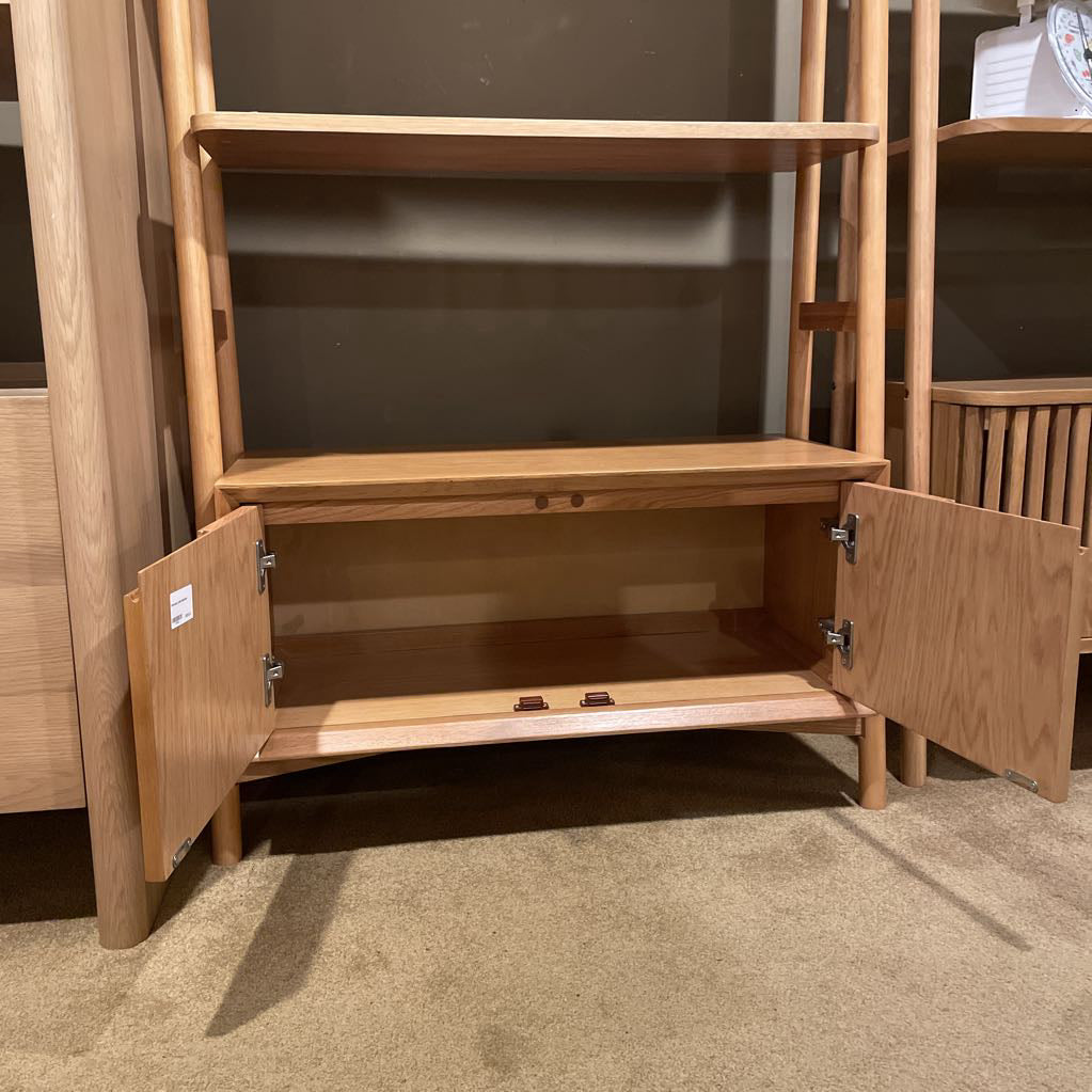 Wooden shelf with open doors in a room setting