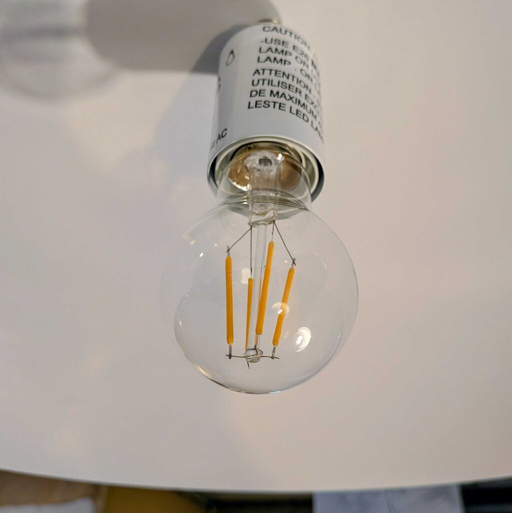 LED light bulb with filament design on a white background