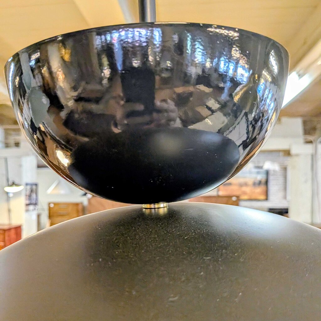 Close-up of a black metal bowl with a blurred indoor background