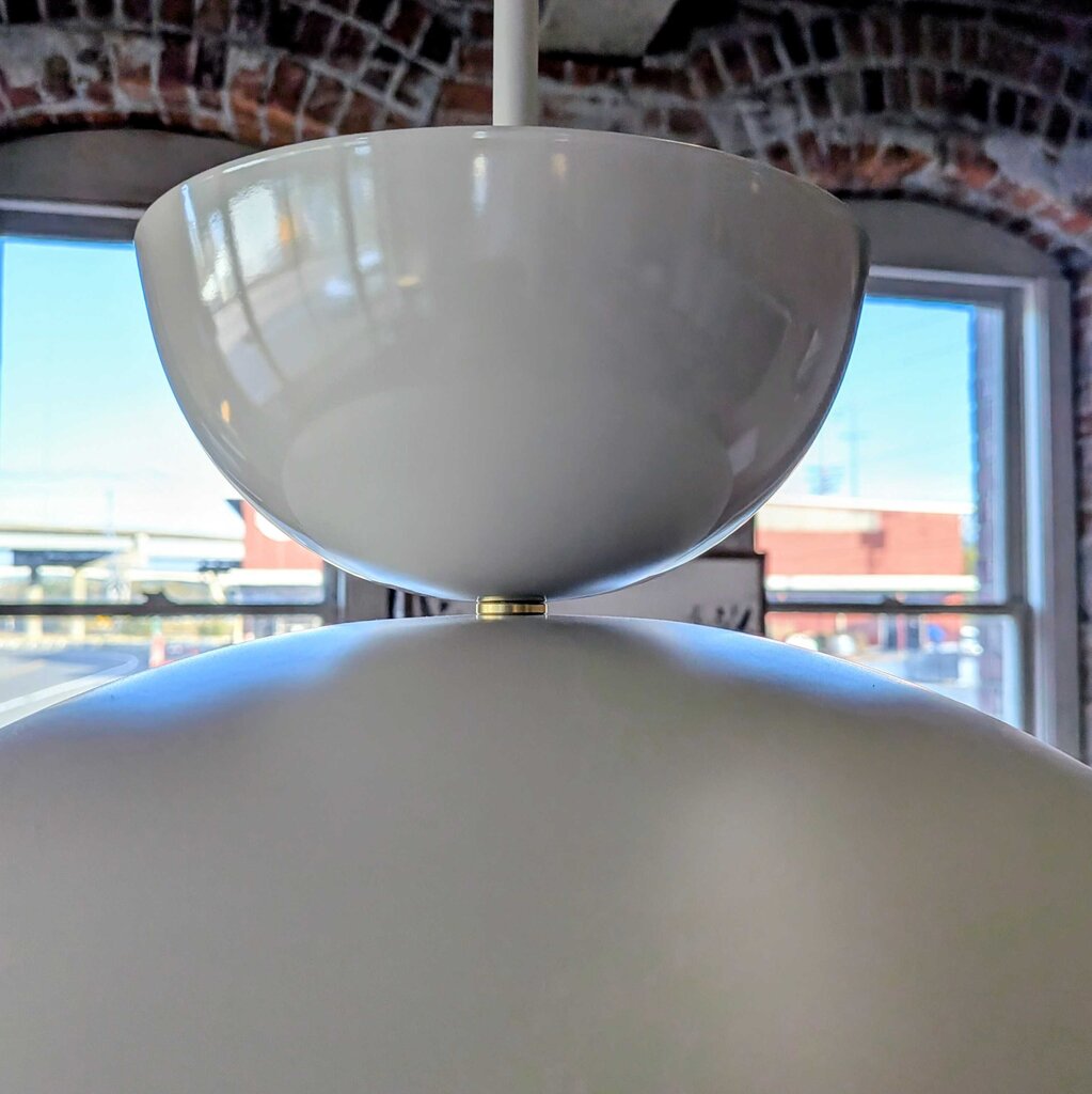 Close-up of a white ceiling fan with a blurred background
