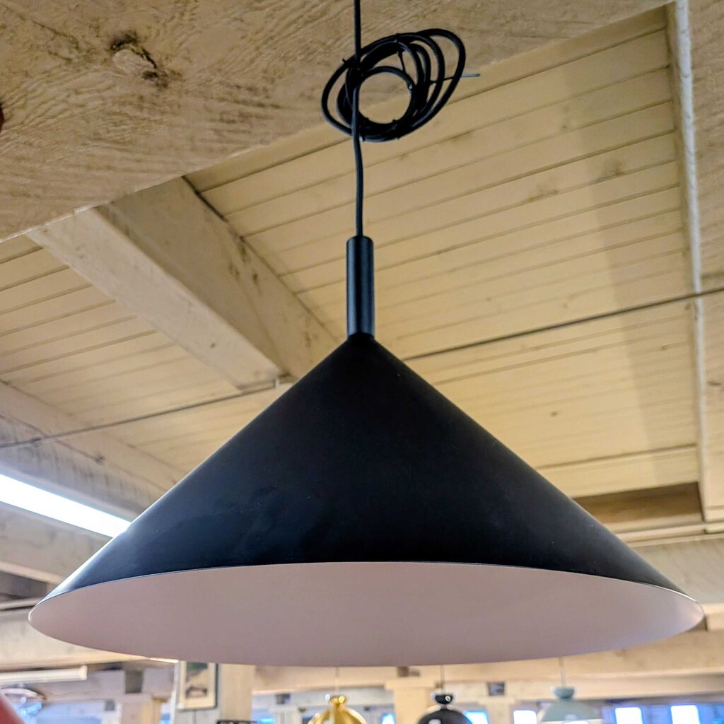 Black pendant light hanging from a ceiling with wooden panels.