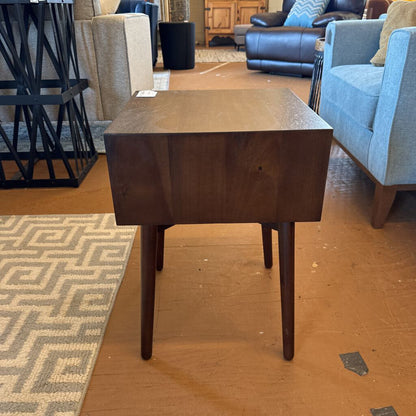 Wooden side table in a room with furniture and decor