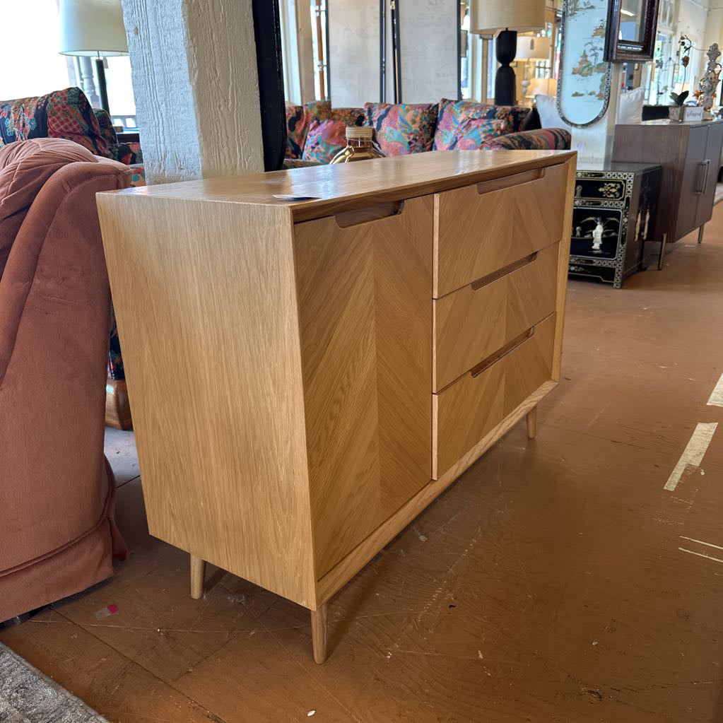 Wooden dresser in a room with colorful furniture and decor