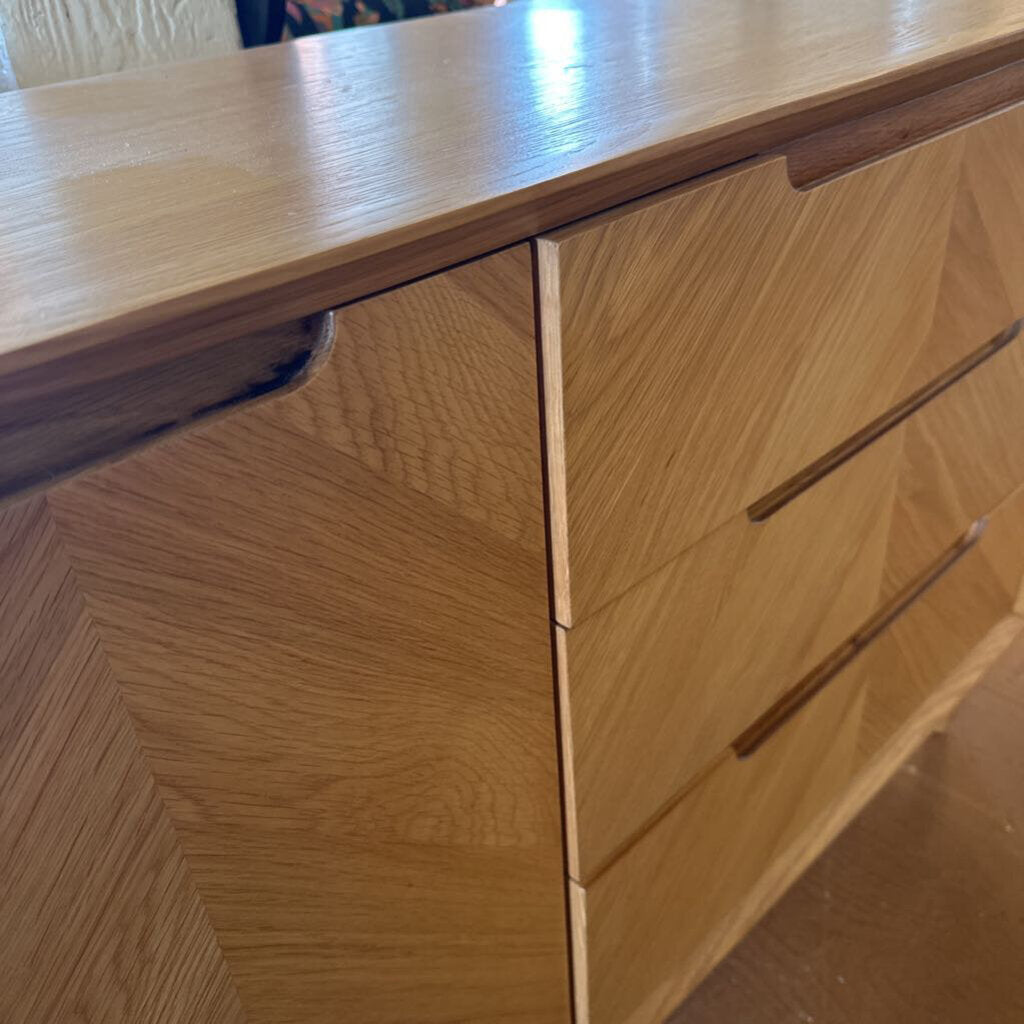 Wooden dresser with two drawers and a partially visible third one.