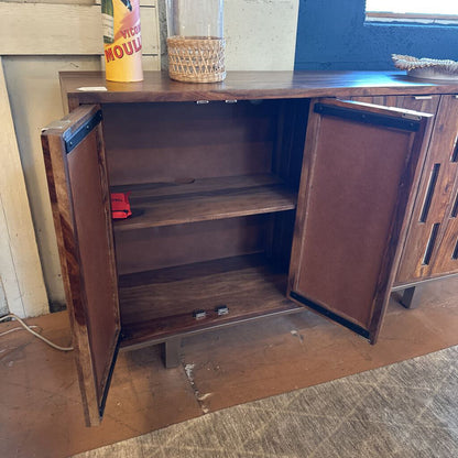 Wooden cabinet with open doors on a wooden floor.