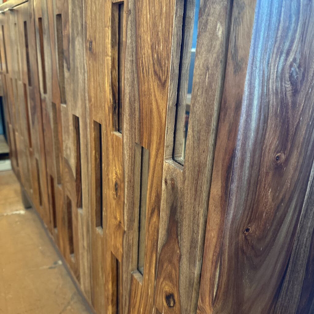 Close-up of a wooden panel with a slatted design