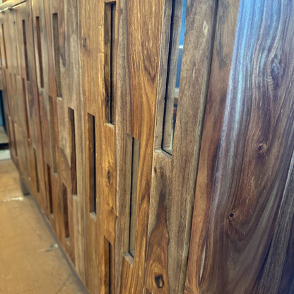 Close-up of a wooden panel with a slatted design