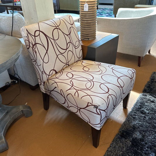 Patterned armchair in a room with furniture and decor