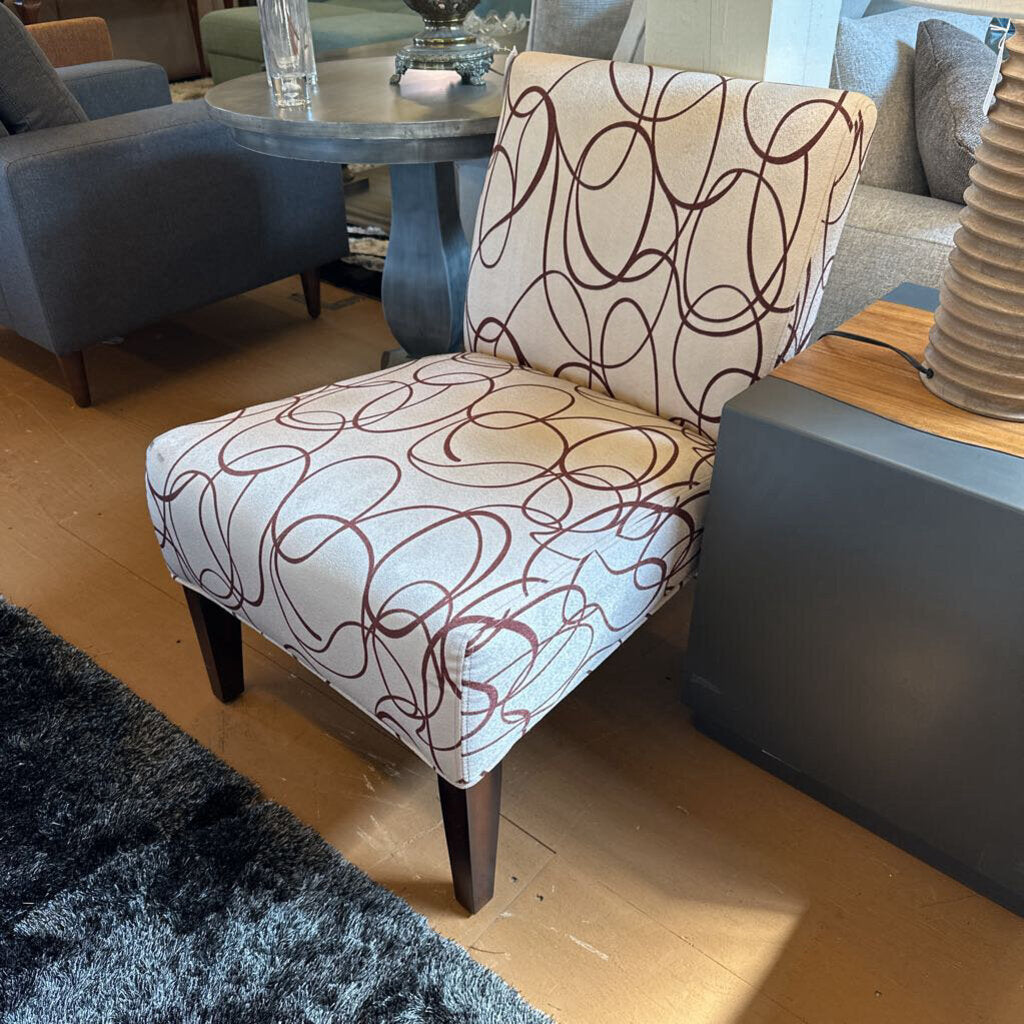 Chair with patterned fabric in a living room setting