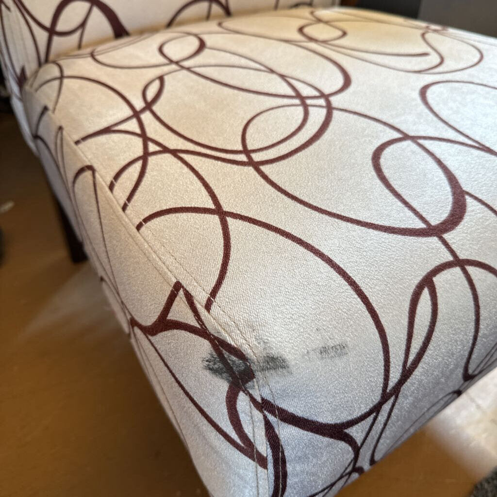 Close-up of a chair with a brown abstract pattern on a beige background