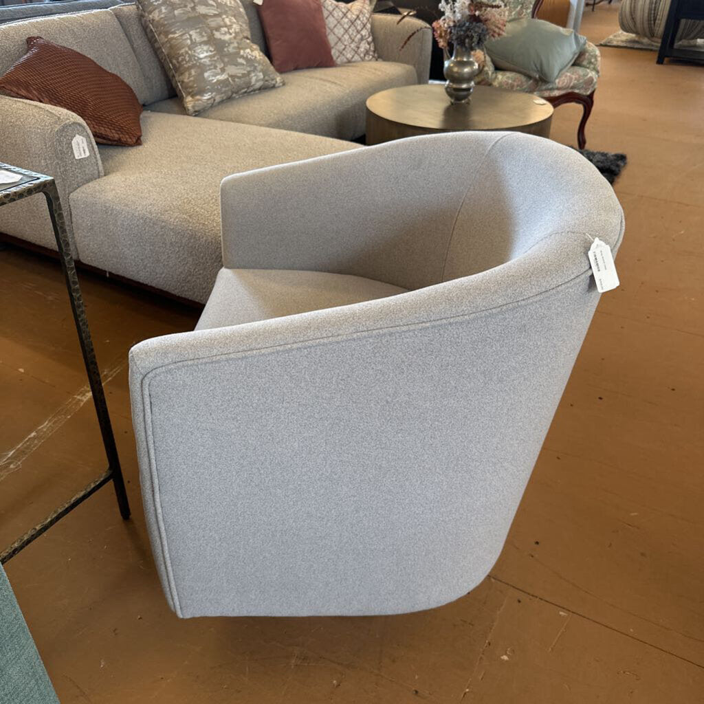 Gray armchair with a price tag in a showroom setting