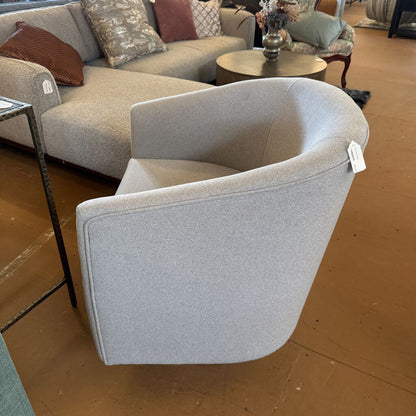 Gray armchair with a price tag in a showroom setting