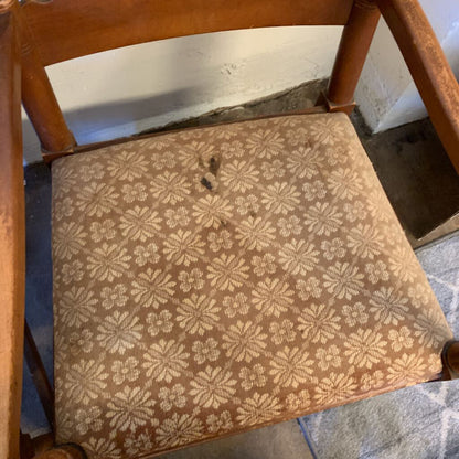 Chair with a patterned cushion on a tiled floor