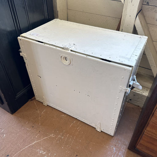 White metal storage box on a wooden floor