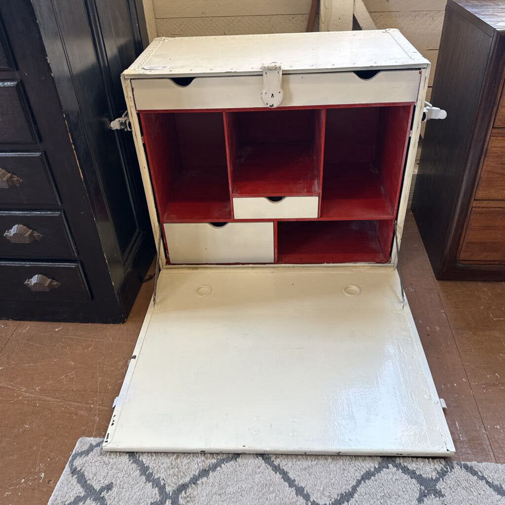 Wooden storage box with red interior compartments on a wooden floor.