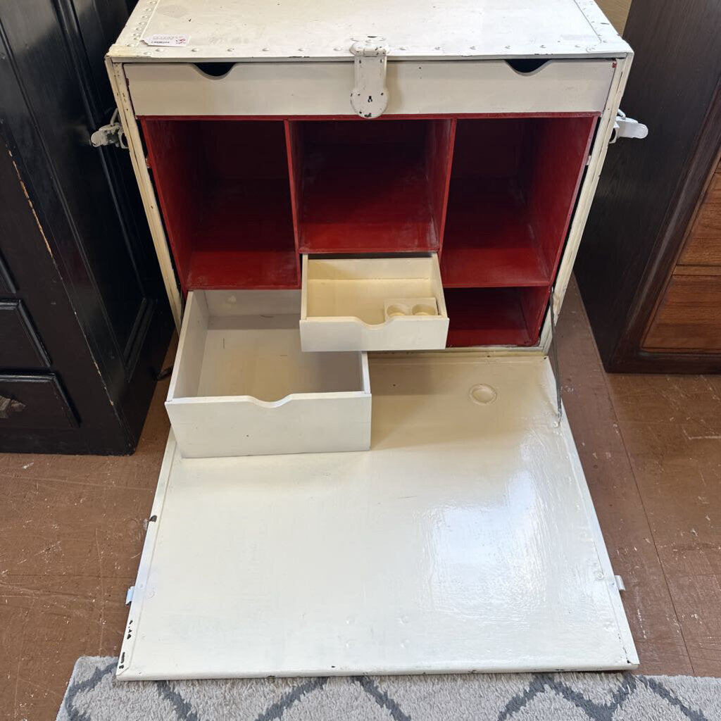 White storage unit with red interior compartments and a white drawer on a floor.