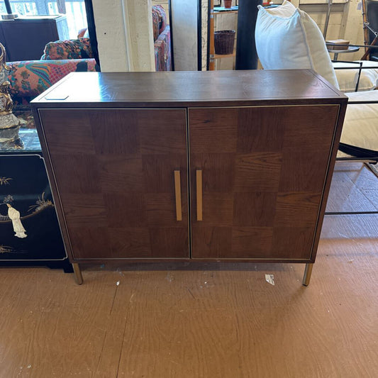 Wooden cabinet with two doors on a wooden floor