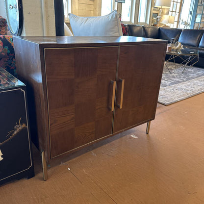 Wooden cabinet with metal legs in a room setting