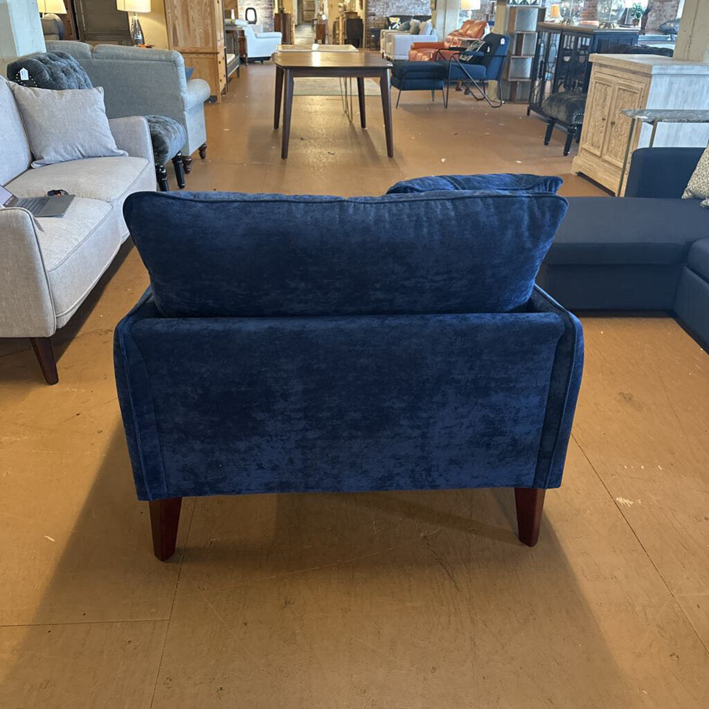Blue sofa in a showroom with other furniture in the background