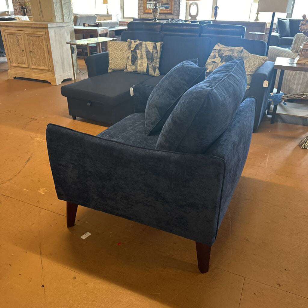 Blue sofa with cushions in a room setting