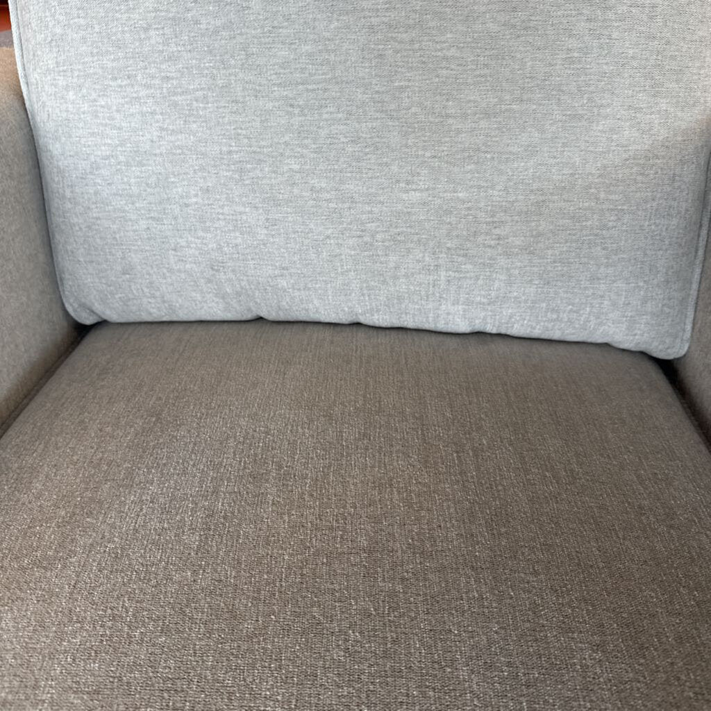 Gray upholstered chair with a textured fabric finish