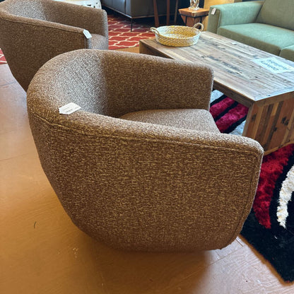 Brown textured armchair in a room with a wooden floor and furniture.