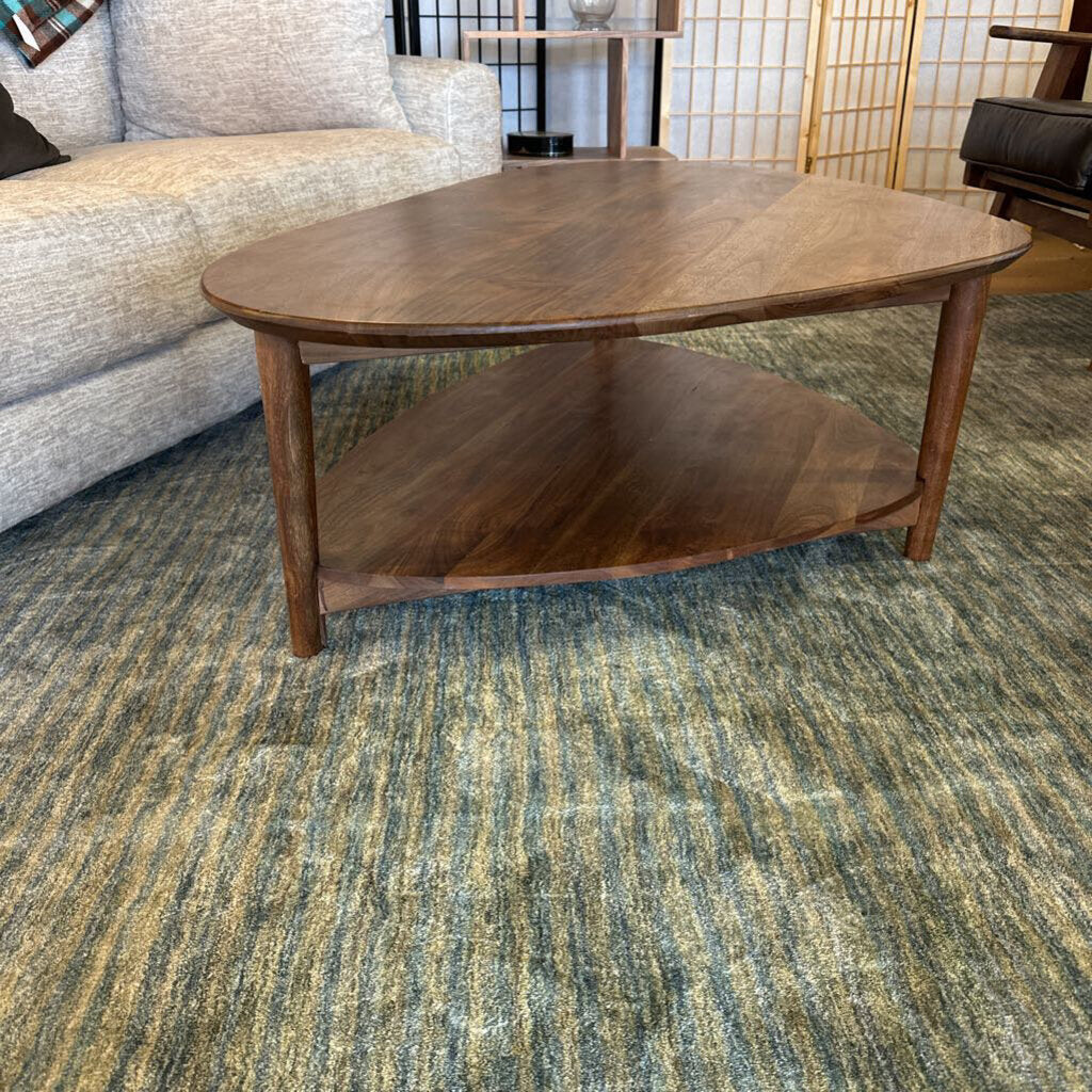 Wooden coffee table in a room with a textured green carpet
