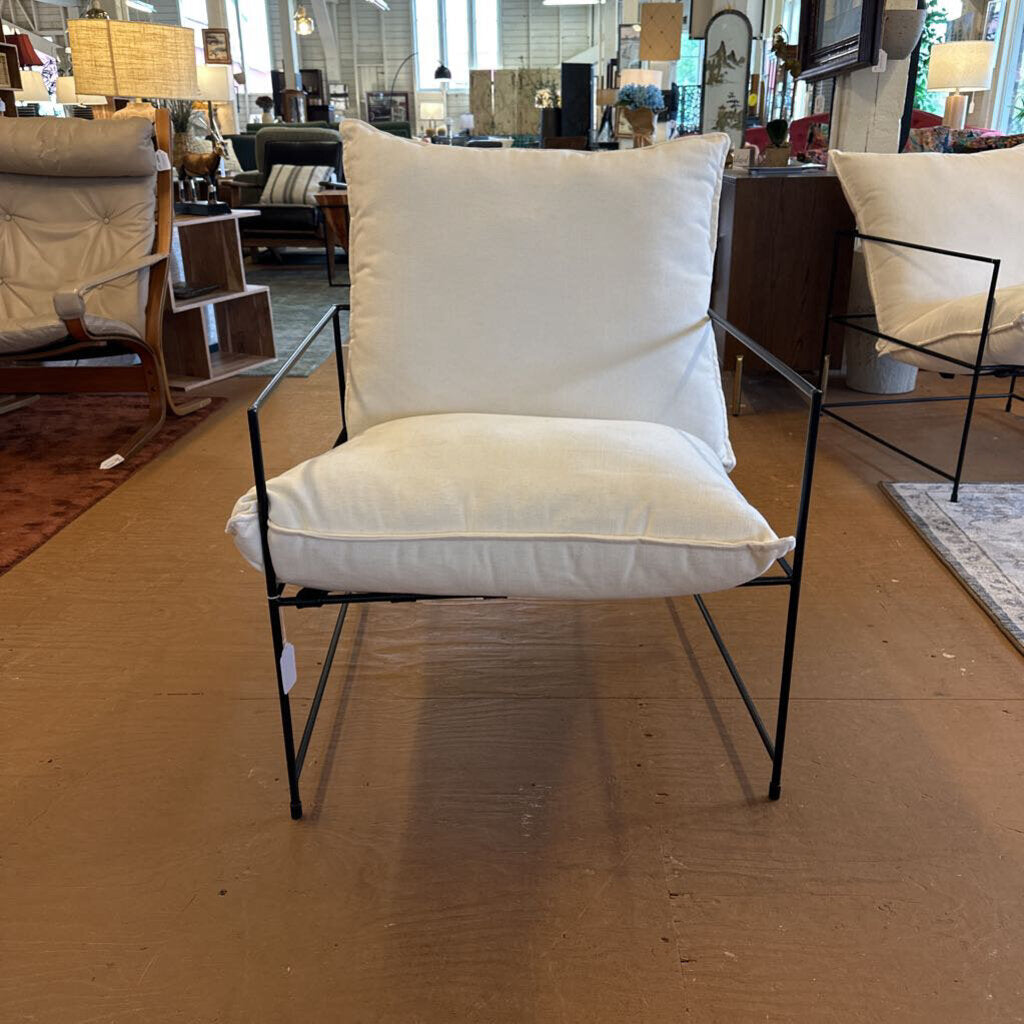 Chair with white cushions in a showroom setting