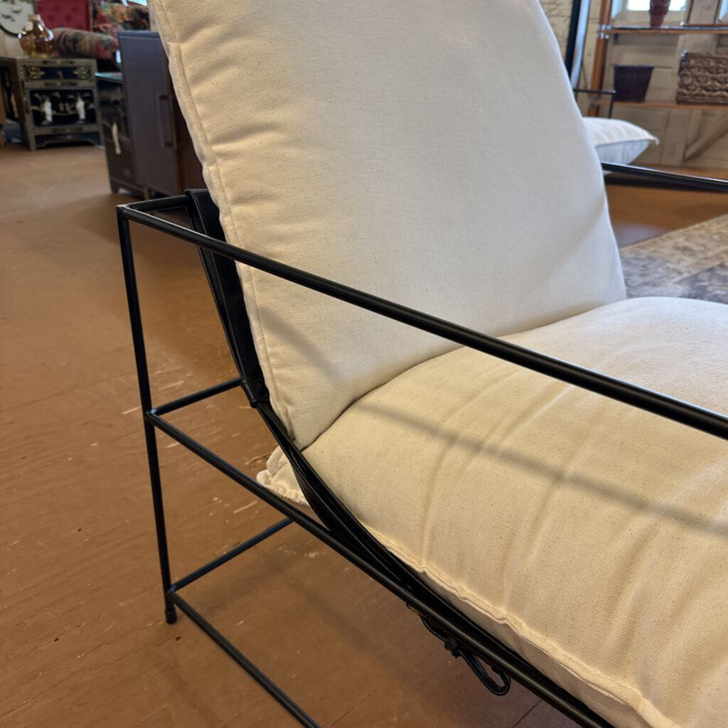 Chair with beige cushions on a wooden floor