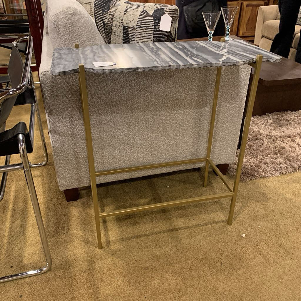 Small table with marble top and gold frame in a room setting