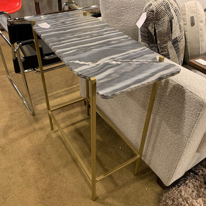 Bar stool with marble top and gold frame in a showroom setting