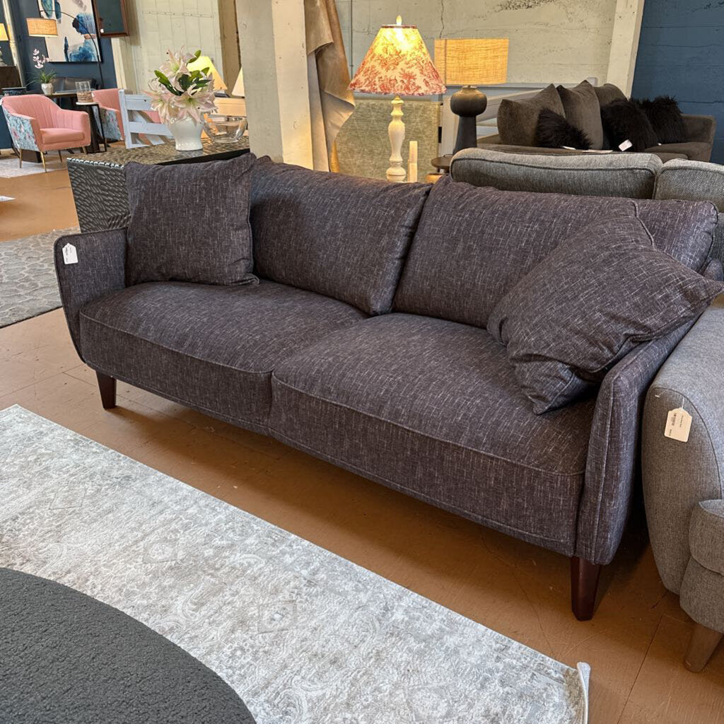 Gray sofa with cushions in a room setting