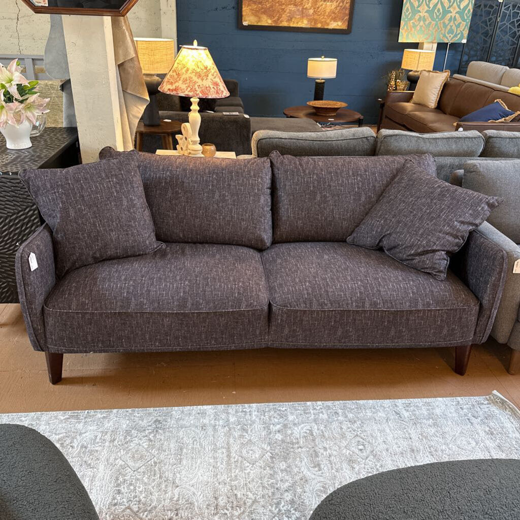 Gray sofa in a room with other furniture and decor