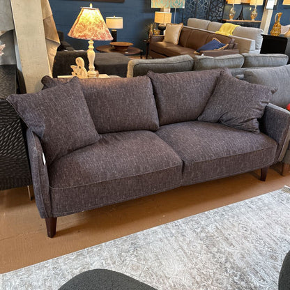 Gray sofa in a room with other furniture and decor
