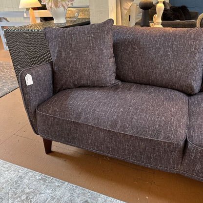 Gray sofa with a pillow in a room setting