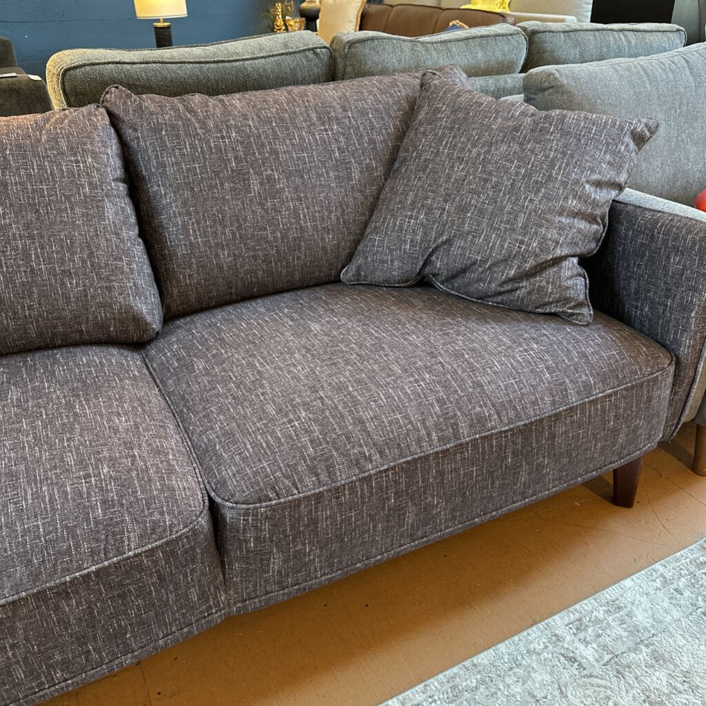 Gray sofa with cushions in a living room setting