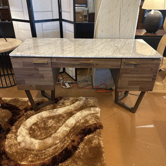 Wooden desk with marble-like top in a room setting