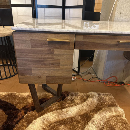Wooden desk with marble top in a room setting