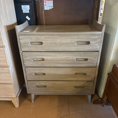 Wooden dresser with four drawers in a room setting