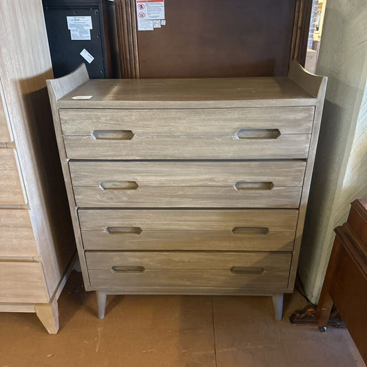Wooden dresser with four drawers in a room setting