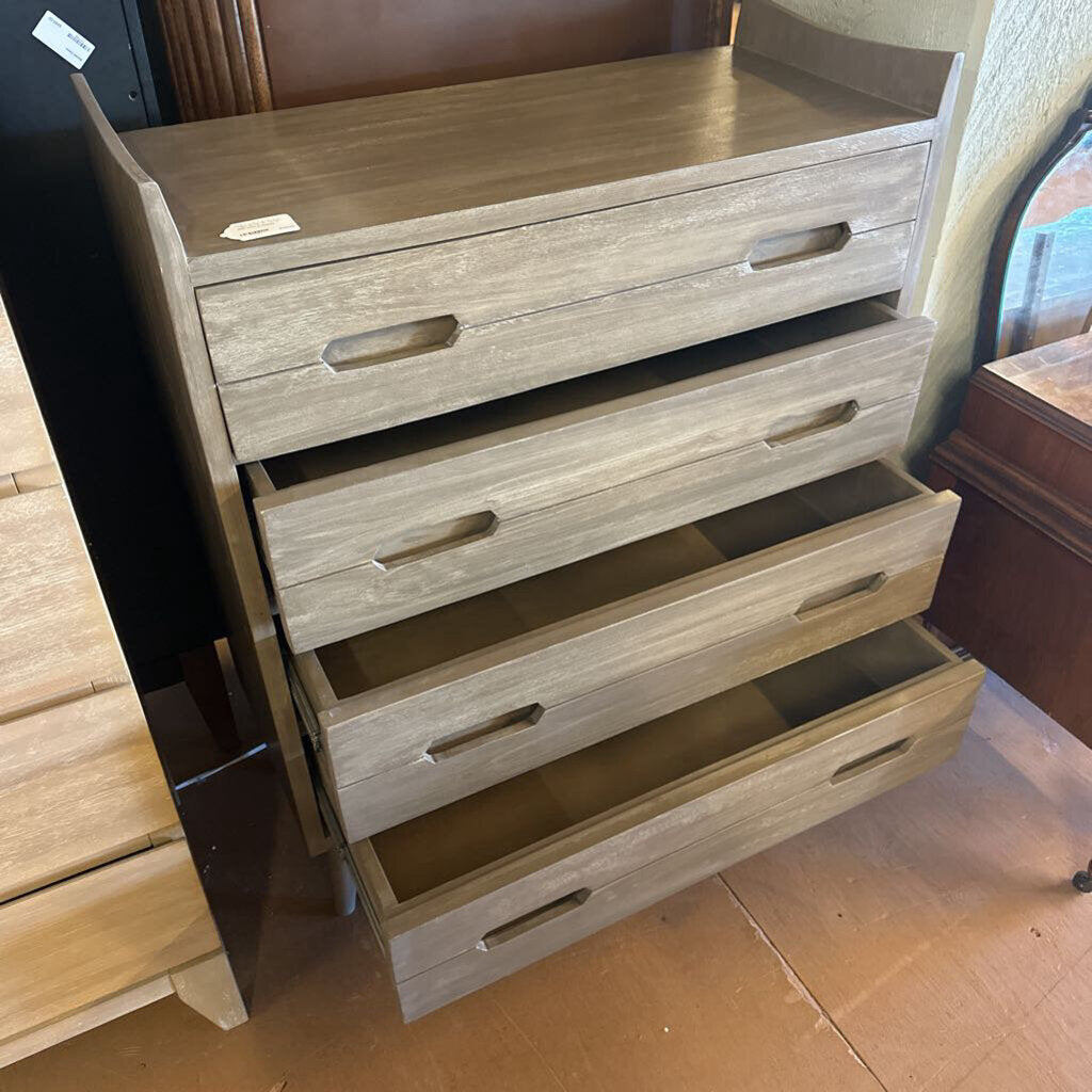 Wooden dresser with multiple drawers in a store setting