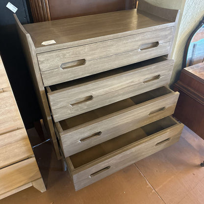 Wooden dresser with multiple drawers in a store setting