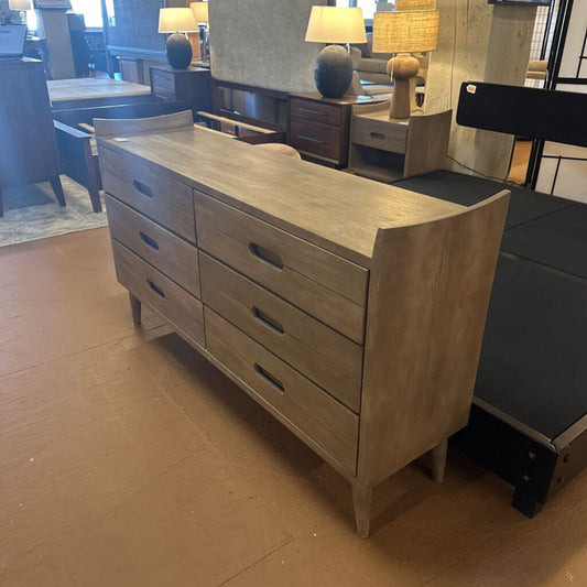 Wooden dresser with multiple drawers in a room setting