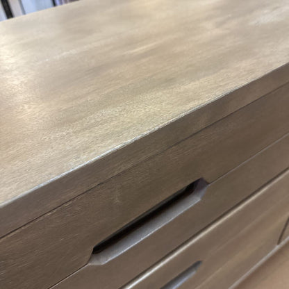 Close-up of a wooden drawer with a visible scratch.