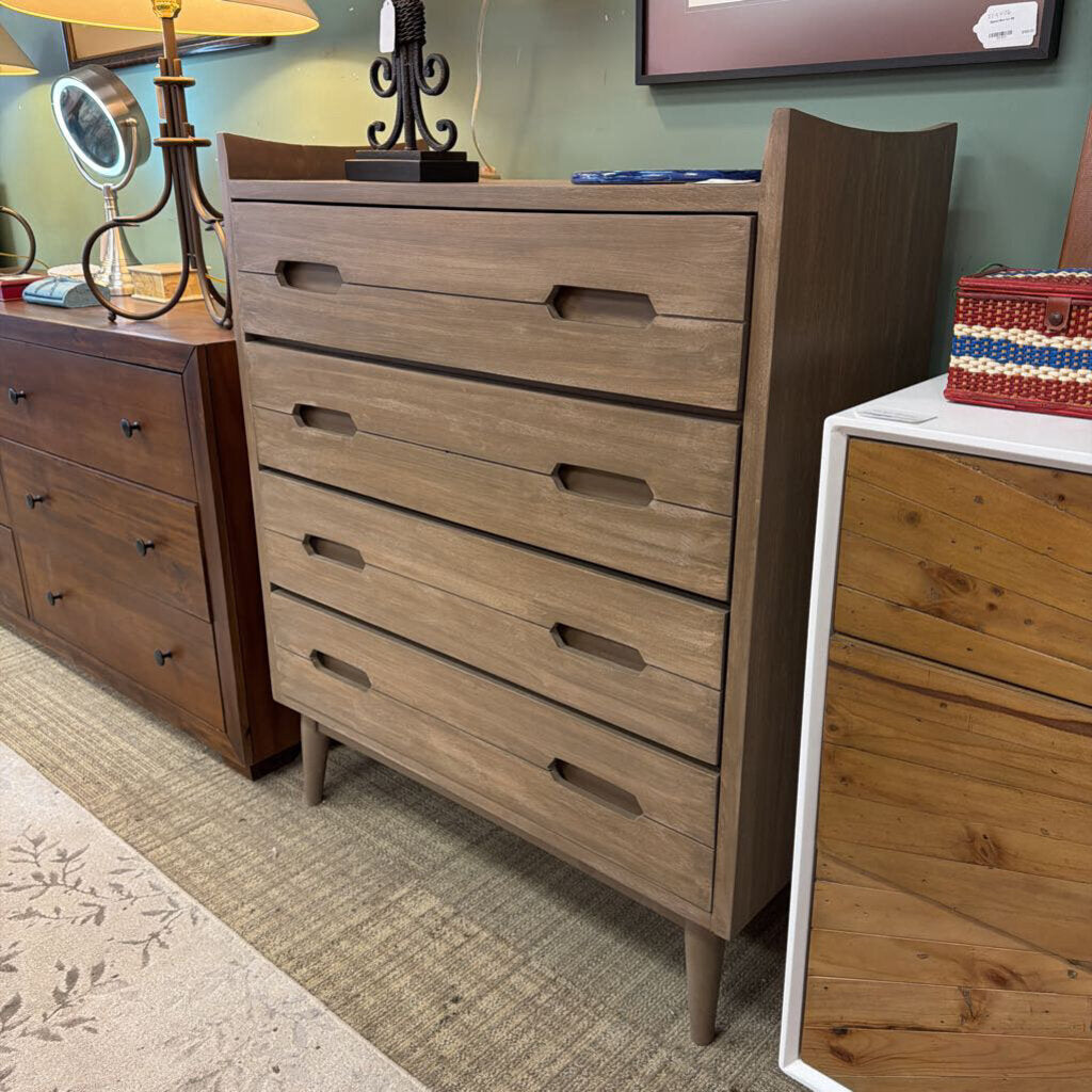 Wooden dresser with multiple drawers in a room setting.