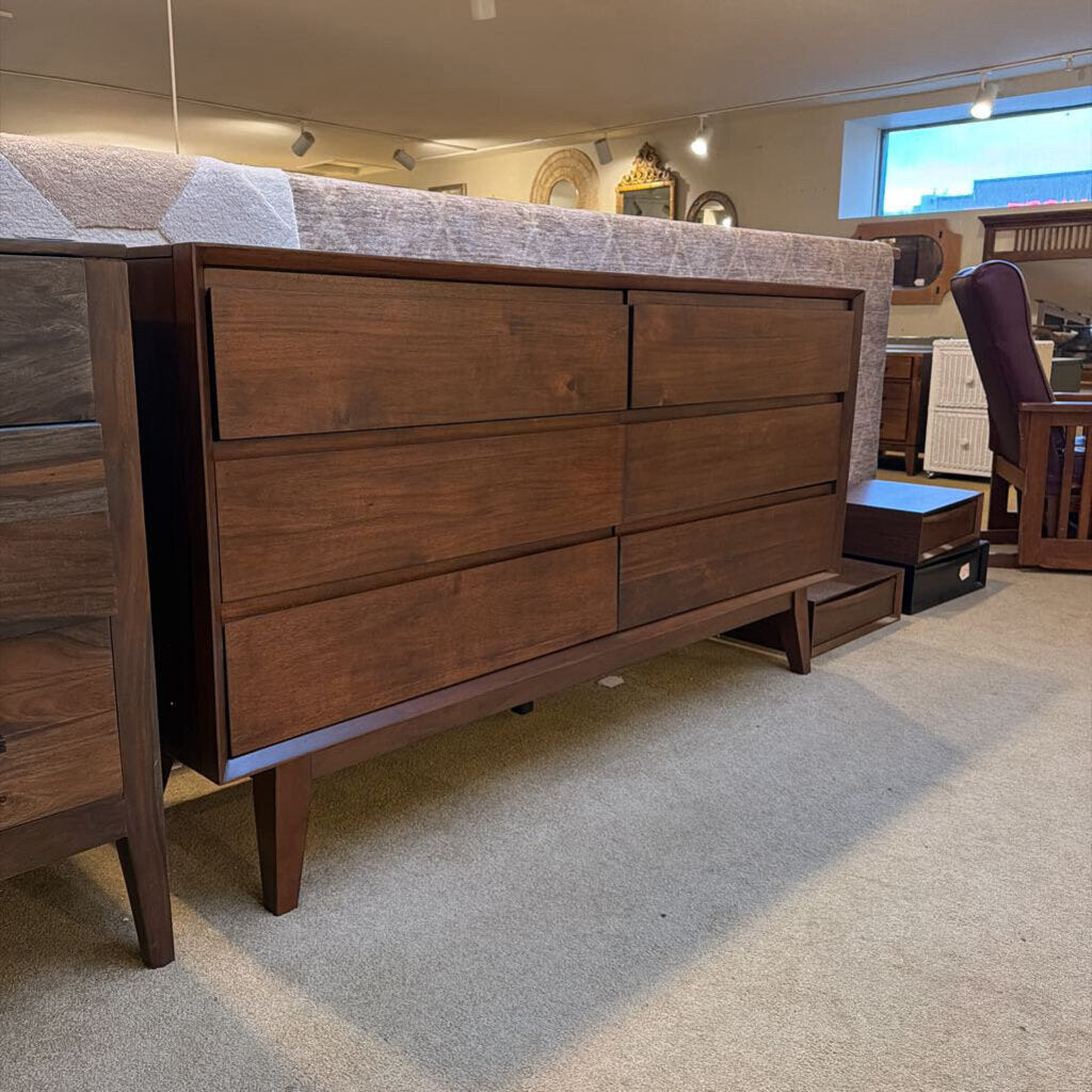 Wooden dresser with multiple drawers in a room setting