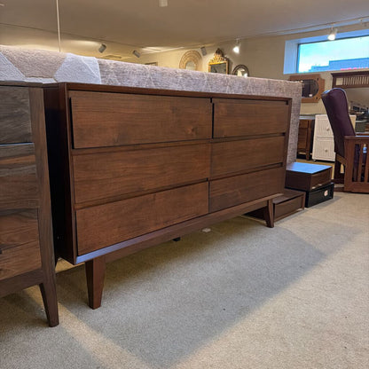 Wooden dresser with multiple drawers in a room setting
