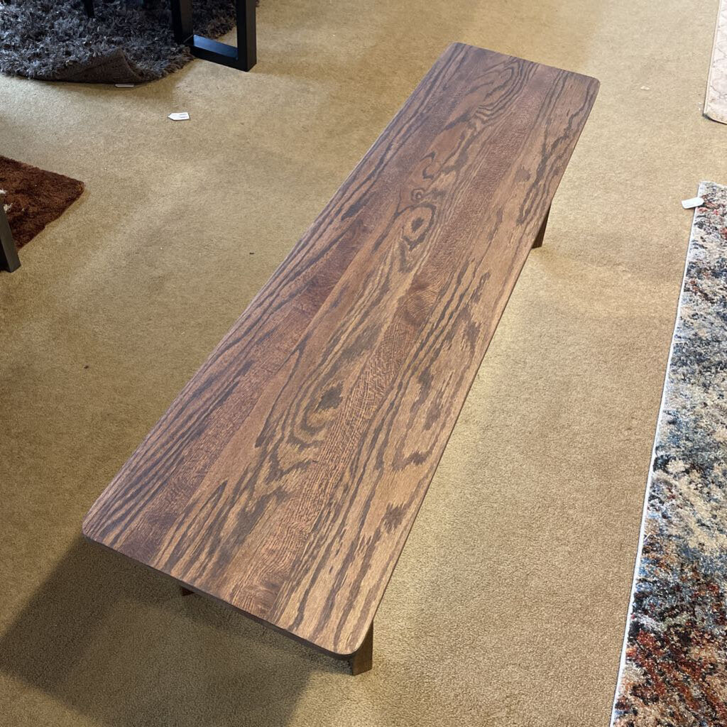 Wooden bench on a carpeted floor