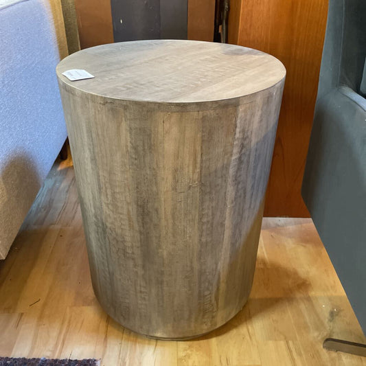 Wooden side table on a wooden floor with a blurred background